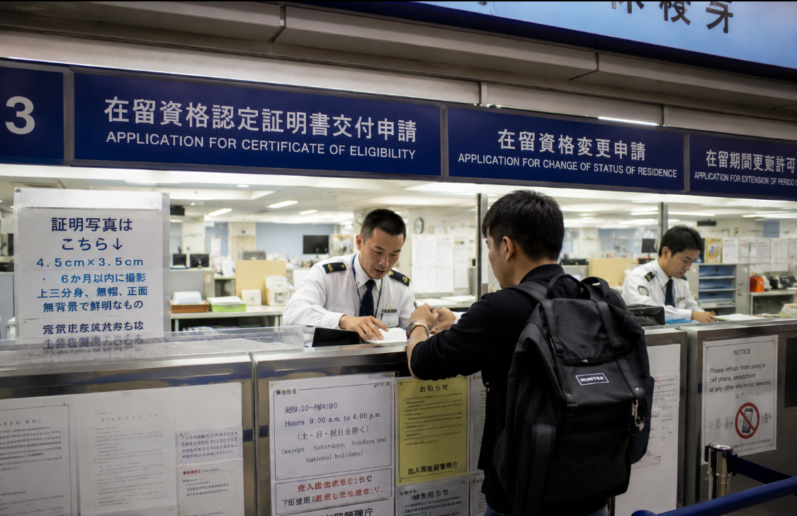 International student submitting Certificate of Eligibility application documents at a Japanese immigration office for Japan student visa processing